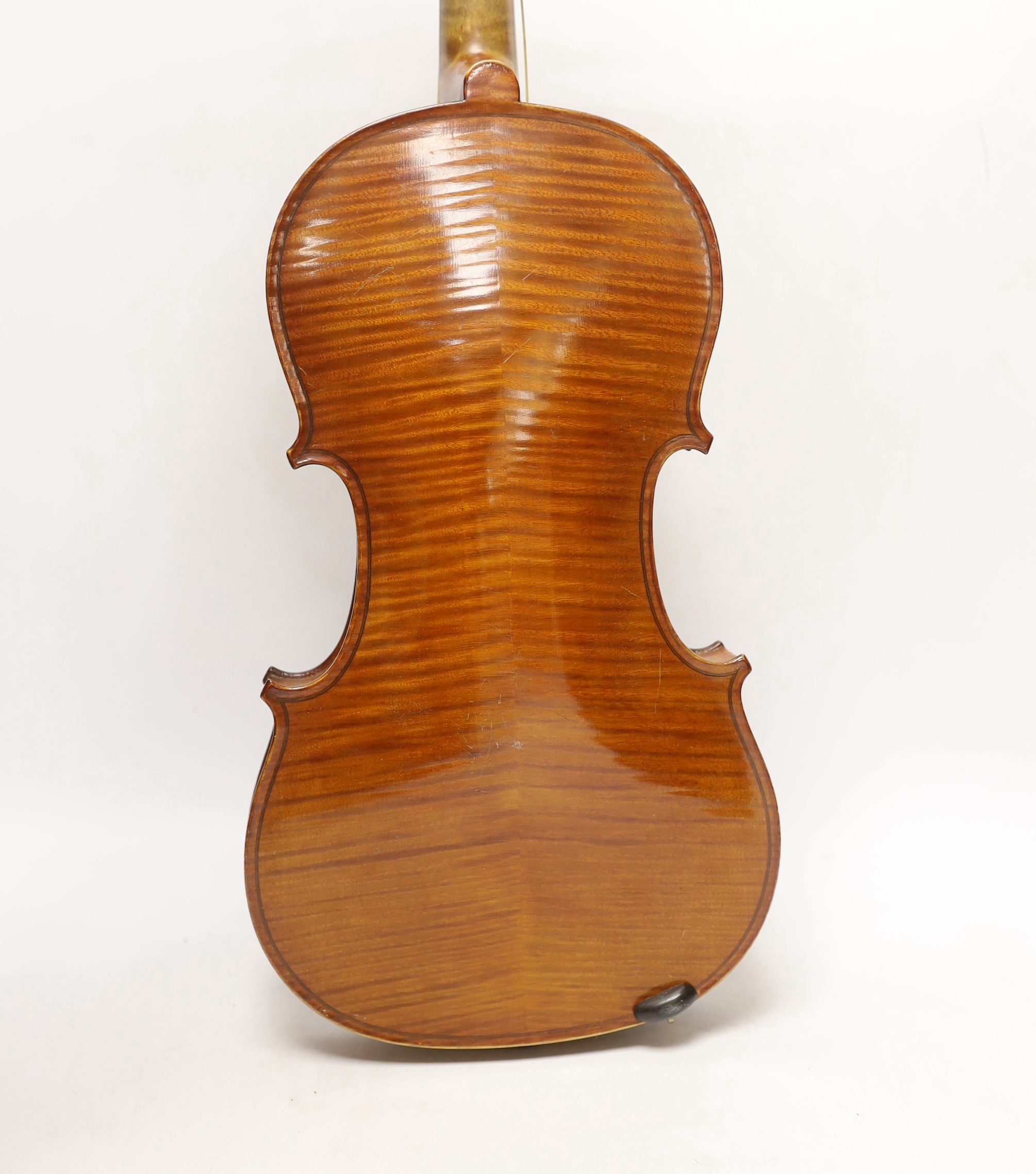 An early 20th century cased violin, length of the back 36cm